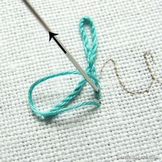 the needle is being used to make a stitch