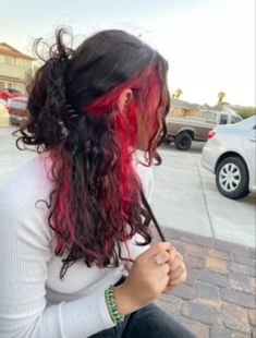 Red Underneath Hair Curly, Curly Hair Red Underneath, Curly Hair With Red Underneath, Peekaboo Hair Color Wavy, Black With Red Highlights Curly Hair, Red Dye Curly Hair, Split Dye On Curly Hair, Curly Hair With Colored Streaks, Long Curly Hair Undercut Woman