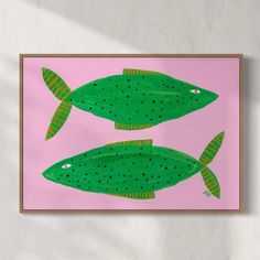 two green fish on a pink background with polka dots in the bottom and bottom part