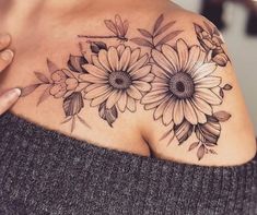 a woman's shoulder with flowers on it