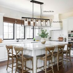 a kitchen island with four stools in front of it