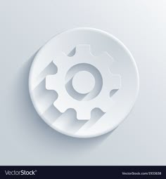 a white circular object with gears on the side and shadow in the middle, against a light gray background