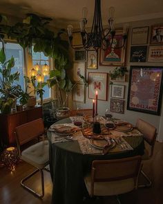 a dining room table is set with food and candles