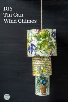 a lamp hanging from a rope with flowers on it and the words diy tin can wind chimes