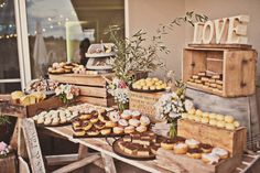 an assortment of desserts displayed on wooden crates