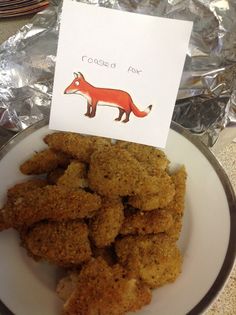 a white plate topped with fried food next to a card that says roasted fox on it