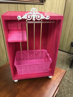 a pink birdcage is sitting on a table