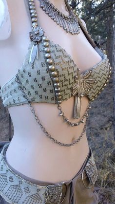 a close up of a mannequin with chains on it's chest and bra