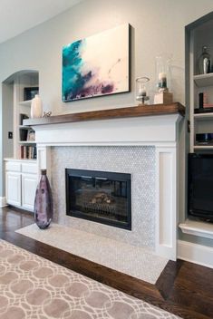 a living room with a fireplace and entertainment center