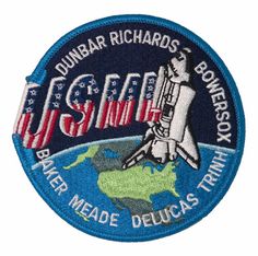 an embroidered patch with the name and image of a space shuttle on top of it