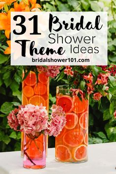 three vases filled with orange slices and flowers on top of a white tablecloth