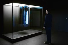 a man standing in front of a glass display case