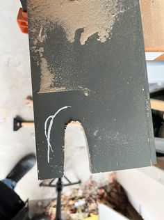 a person holding up a piece of black paint