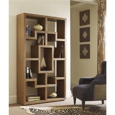 a living room with a chair, book shelf and zebra print rug on the floor