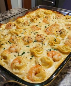 a casserole dish with shrimp and dumplings in it sitting on a counter