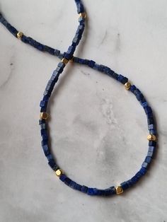 The dainty Lapis Lazuli necklace features 24k gold filled beads and is designed as a genuine natural Lapis Lazuli choker, making it an exquisite gemstone necklace perfect for those born under the Sagittarius zodiac sign, as it incorporates their birthstone. You will receive 1 necklace. 👀Discover Similar Dainty Jewelries https://www.etsy.com/shop/demetergemart/?etsrc=sdt§ion_id=44637022 ✨MATERIALS The gemstones are Lapis lazuli. The cube beads are 24k gold filled. The lobster claw clasp, extensi Sagittarius Zodiac, Lapis Lazuli Necklace, Cube Beads, Zodiac Sagittarius, December Birthstone, Dainty Jewelry, Gemstone Necklace, Lapis Lazuli, Lobster Claw