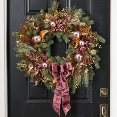 a christmas wreath hanging on the front door