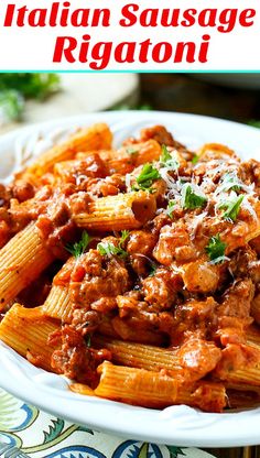 pasta with meat sauce and parmesan cheese in a white bowl on a table