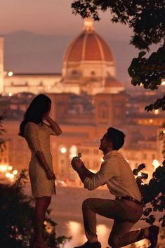 a man kneeling down next to a woman