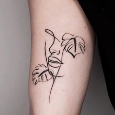 a woman's leg with a line work tattoo on her left thigh and the word love written in black ink