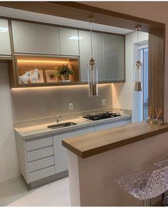 a kitchen with white cabinets and counter tops