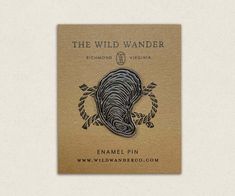 the wild wander pin is shown in black and white, with an elephant's head on