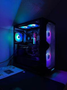 a computer case sitting on top of a desk next to a mouse and keyboard in a dark room