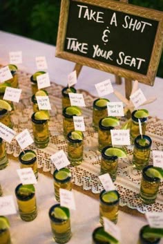 there are many shot glasses with limes in them on the table next to each other