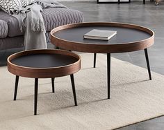 two coffee tables sitting on top of a rug