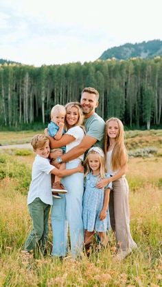 a family posing for a photo in a field