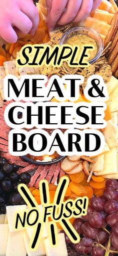 a platter with cheese, grapes and crackers on it that says simple meat and cheese board