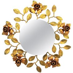 a mirror with gold leaves and flowers around it