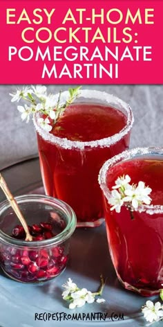 two glasses filled with cranberry pomegranate martinis on top of a table