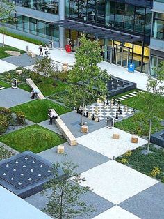 an aerial view of a courtyard with chess boards and trees