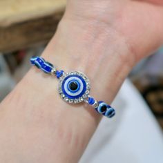 The Evil Eye charm has been used for centuries as a talisman for protection against misfortune and malicious intent. It is thought to bring the wearer good luck.This adjustable sliding knot bracelet comes in an assortment of evil eye styles in a silver finish. Adjustable Traditional Evil Eye Bracelet, Traditional Adjustable Evil Eye Bracelet, Symbolic Friendship Bracelets, Symbolic Adjustable Friendship Bracelets, Symbolic Evil Eye Bracelet For Friendship, Adjustable Evil Eye Bracelet With Sliding Knot, Adjustable Spiritual Evil Eye Bracelet With Sliding Knot, Adjustable Round Spiritual Evil Eye Bracelet, Adjustable Bohemian Evil Eye Bracelet For Good Luck