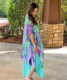 The Vacay My Way Sunrise Print Tassel Kimono is the perfect addition to any vacation wardrobe. This kimono is designed with a stunning sunrise print in shades of pink, green, and purple, evoking feelings of warmth and relaxation. The playful tassel detailing adds a touch of fun and whimsy, making this kimono the perfect accessory for any summer adventure.
This kimono is versatile and can be worn as a swimsuit cover-up or layered over a dress for a stylish look. The lightweight and flowy fabric m Vibrant Spring Vacation Cover-up, Purple Beach Cover-up For Spring, Purple Cover-up For Spring Beach Occasions, Spring Purple Beach Cover-up, Vibrant Multicolor Kimono For Vacation, Green Beachwear Kimono For Spring, Spring Beachwear Green Kimono, Green Tropical Kimono For Summer, Green Tropical Summer Kimono