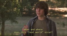 a young man standing in front of a tree with a quote on it that reads, when and where does this real world occupy?