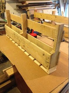 a wooden crate sitting on top of a table next to a workbench filled with tools