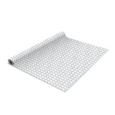 a roll of white paper on top of a mat with holes in the middle and bottom