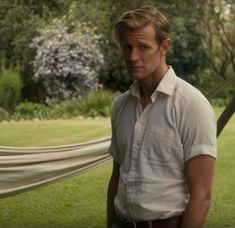 a man standing in front of a hammock