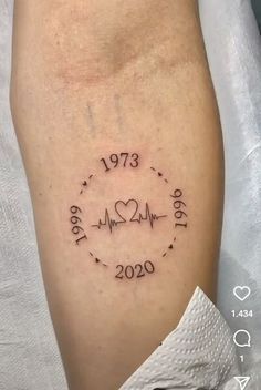 a woman's arm with a heartbeat and date tattoo on the left side of her leg