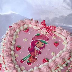 a strawberry shortcake decorated with pink icing