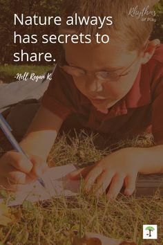 a young boy is writing in the grass