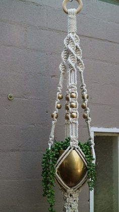 a macrame plant hanging from a hook