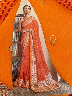 Fabulous soft lariya print saree with soft foil print and piping edge comes with silk unstitched blouse piece Orange Bandhani Print Blouse Piece, Semi-stitched Orange Blouse Piece With Bandhani Print, Bollywood Style Blouse With Printed Border For Navratri, Georgette Saree With Printed Motifs, Diwali Georgette Saree With Printed Motifs, Festive Pre-draped Saree With Printed Border, Orange Bandhani Print Saree For Navratri, Eid Pre-draped Semi-stitched Saree With Printed Motifs, Orange Saree With Printed Border In Traditional Drape