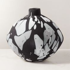 a black and white vase sitting on top of a table