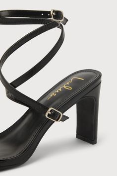 We're obsessed with how easy it is to style the Lulus Dara Black Ankle Wrap High Heel Sandals! Smooth faux leather shapes these chic heels that feature an almond-shaped toe bed and a slender, adjustable toe strap that secures with a silver buckle. Matching straps sprout from the sides, wrap around the ankle, and secures with silver buckles atop a sculpted block heel. 3. 5" wrapped block heel. Cushioned insole. Rubber sole has nonskid markings. Man made materials. Imported. Lulus | Dara Black Ank Chic Heels With Padded Heel And Single Toe Strap, Chic Heels With Sculpted Heel And Single Toe Strap, Chic Heels With Single Toe Strap And Heel Loop, Evening Heels With Stacked Heel And Single Toe Strap, Square Toe Heels With Heel Strap For Date Night, Square Toe Heels With Sculpted Heel For Date Night, Sculpted Heel Square Toe Heels For Date Night, Chic Square Toe Heels For Date Night, Pointed Toe Sandals With Padded Heel For Date Night