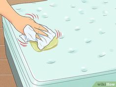 a person cleaning a mattress with a cloth