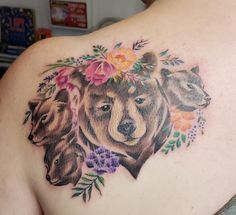 a woman's back with three bears and flowers on it