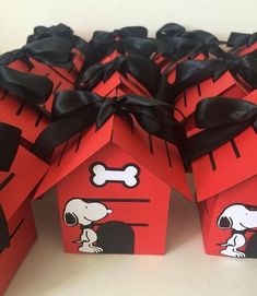 some red boxes with black bows and a dog house on them are decorated like houses